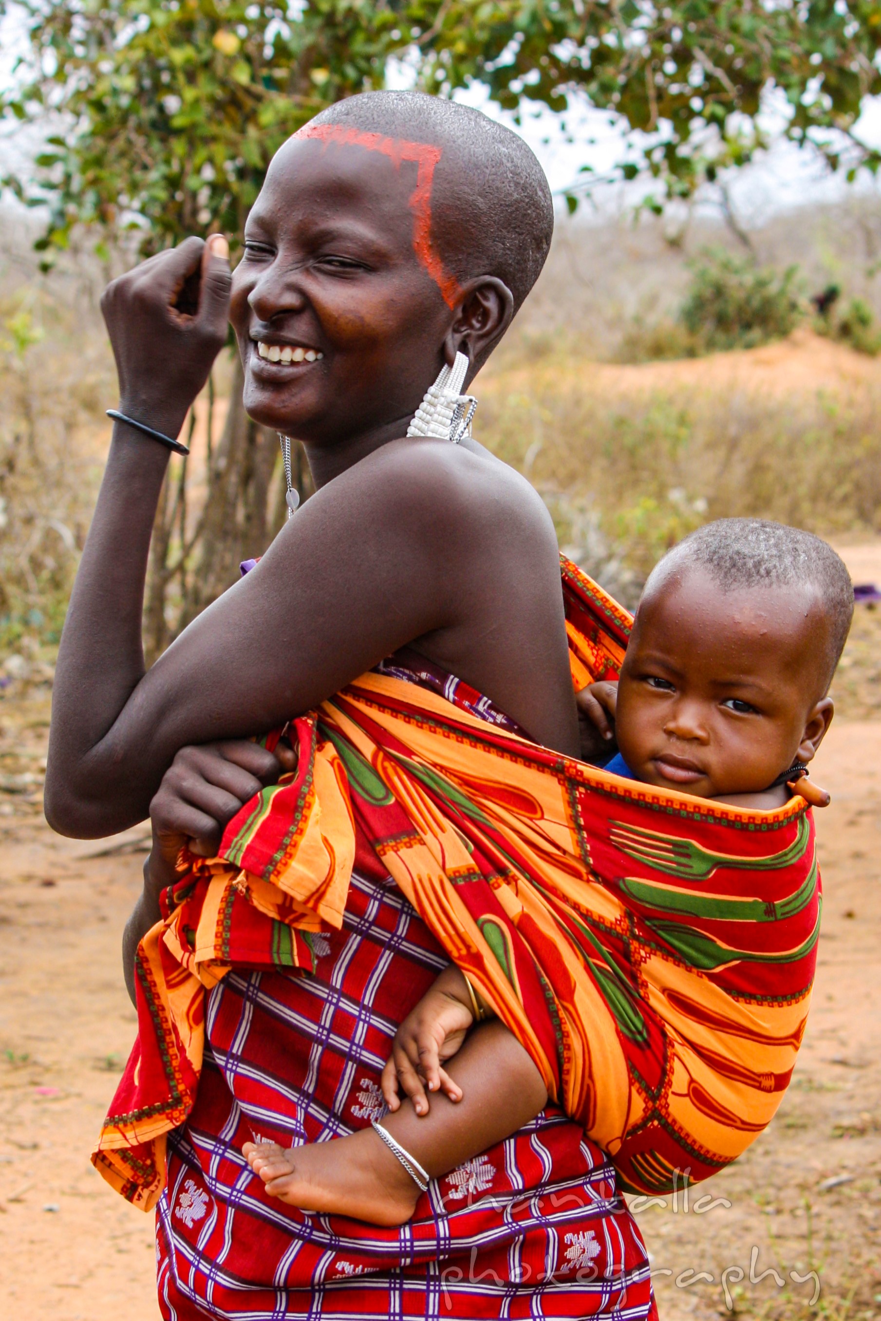 This traditional Masai woman lives in Kenya, and posed for the camera with her beautiful baby.