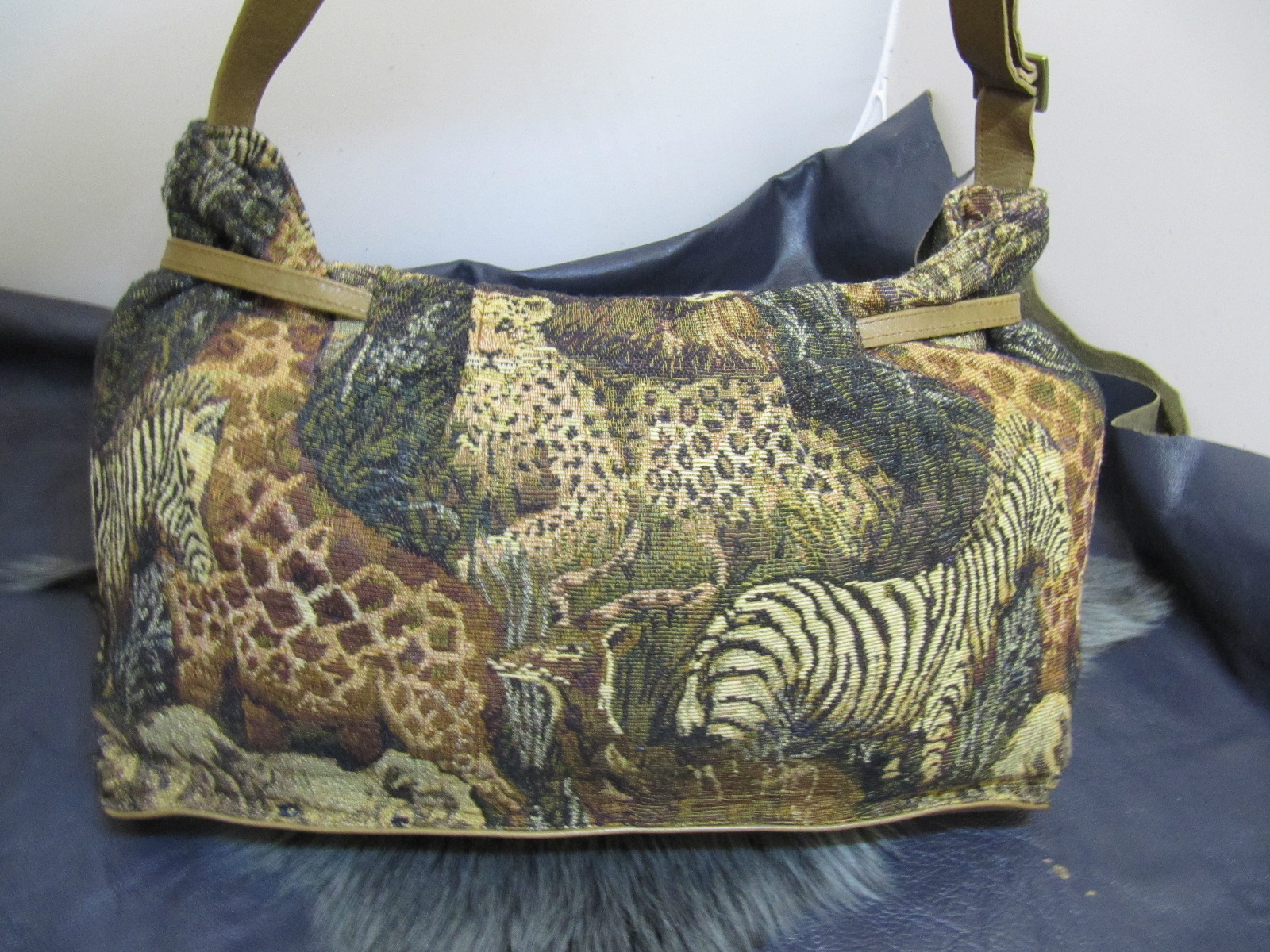 Wildlife fabric and tan leather handbag