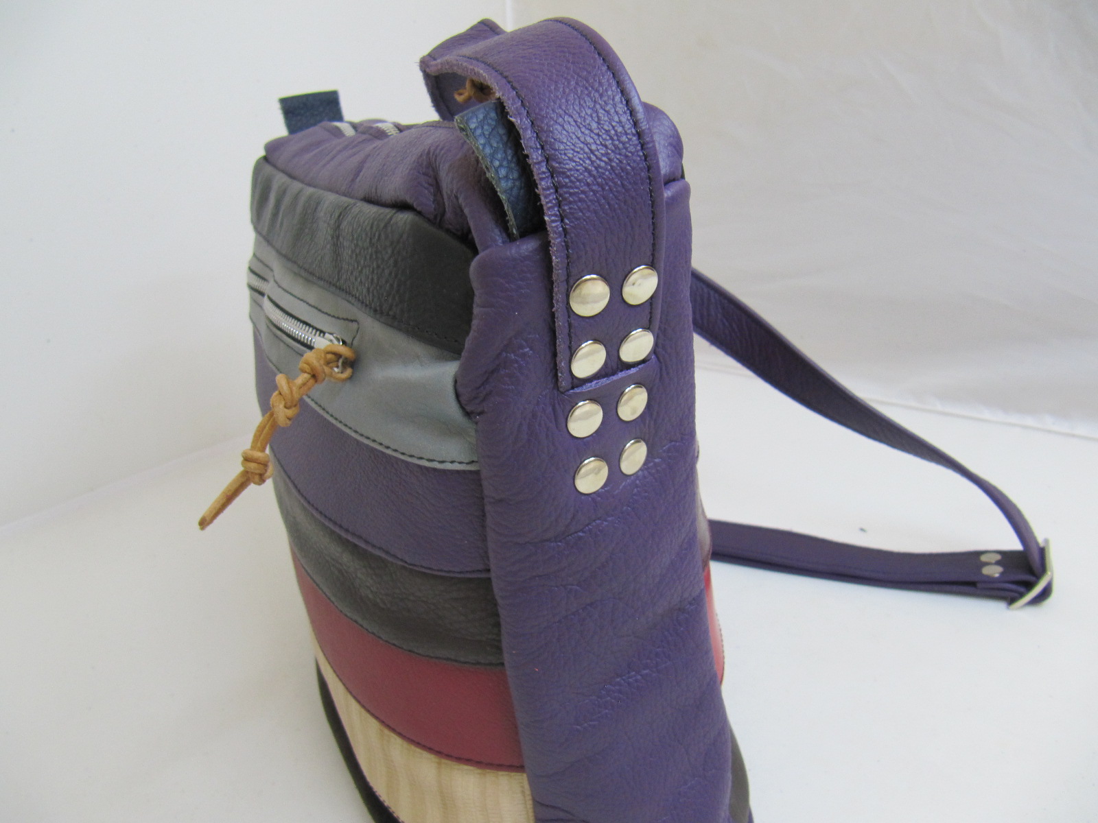 Leather stripe handbag in purples