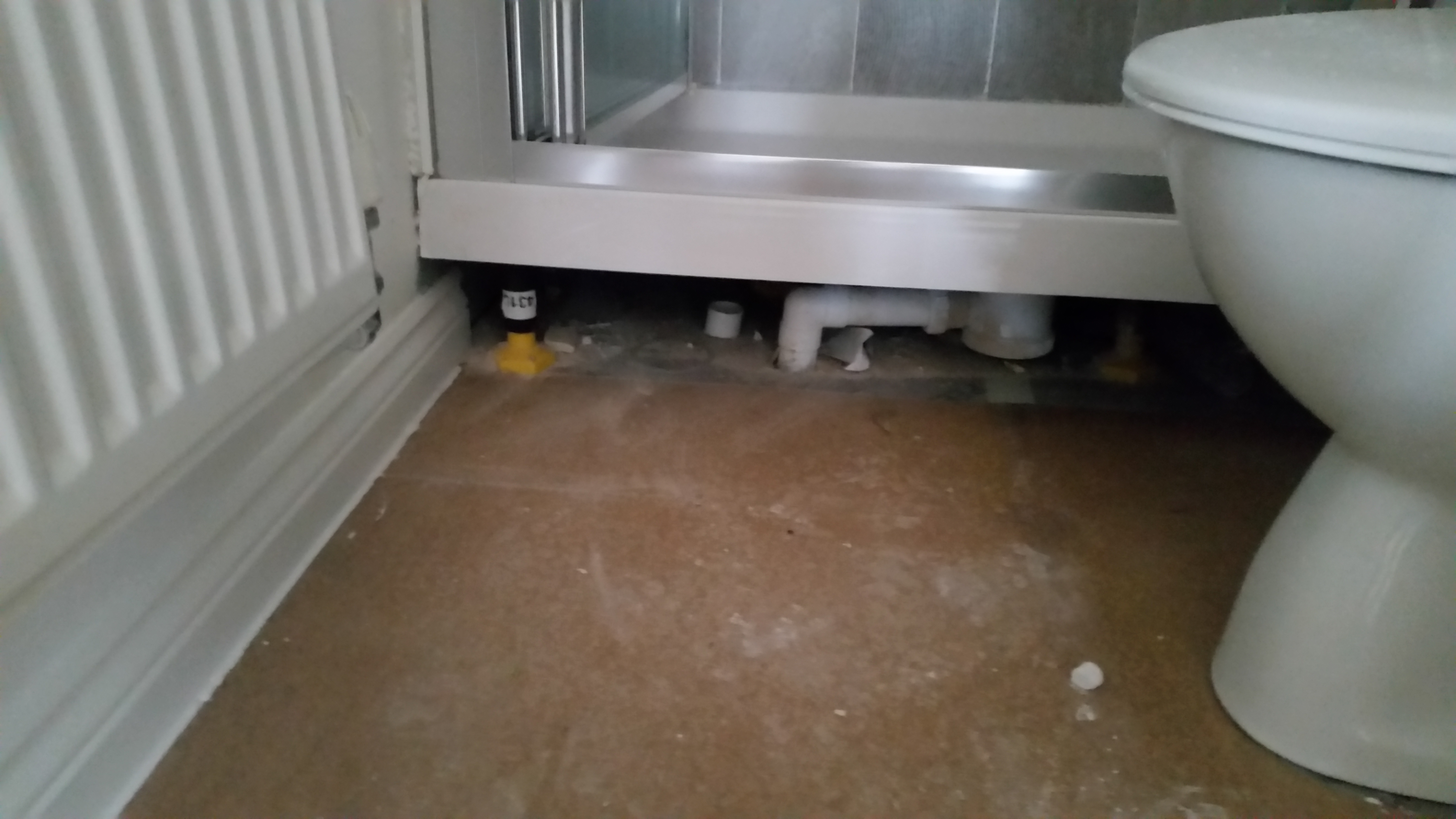 Fill any gaps under the shower tray and fit the front.