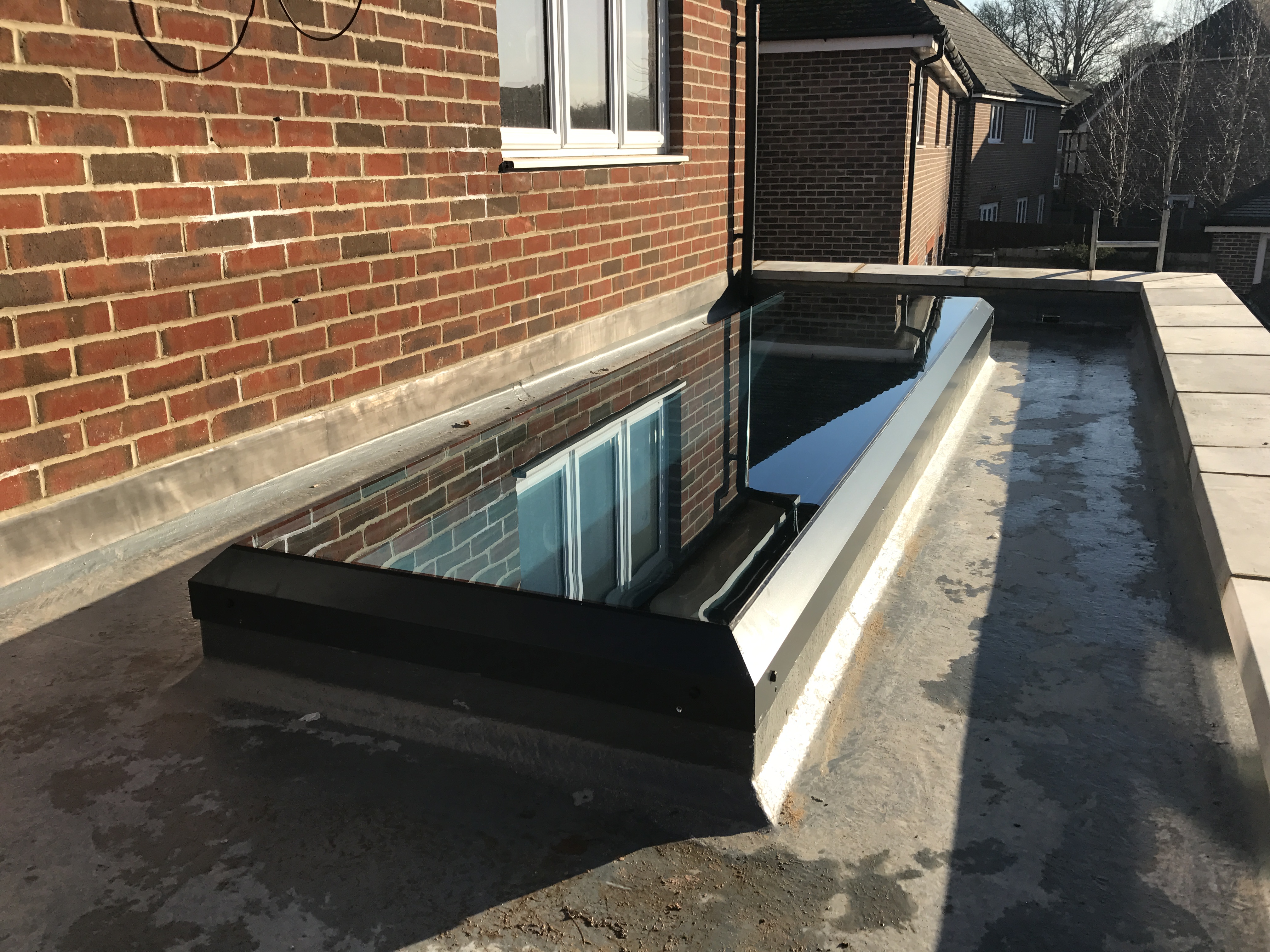 Tinted flat skylight and upstand into flat roof with EPDM