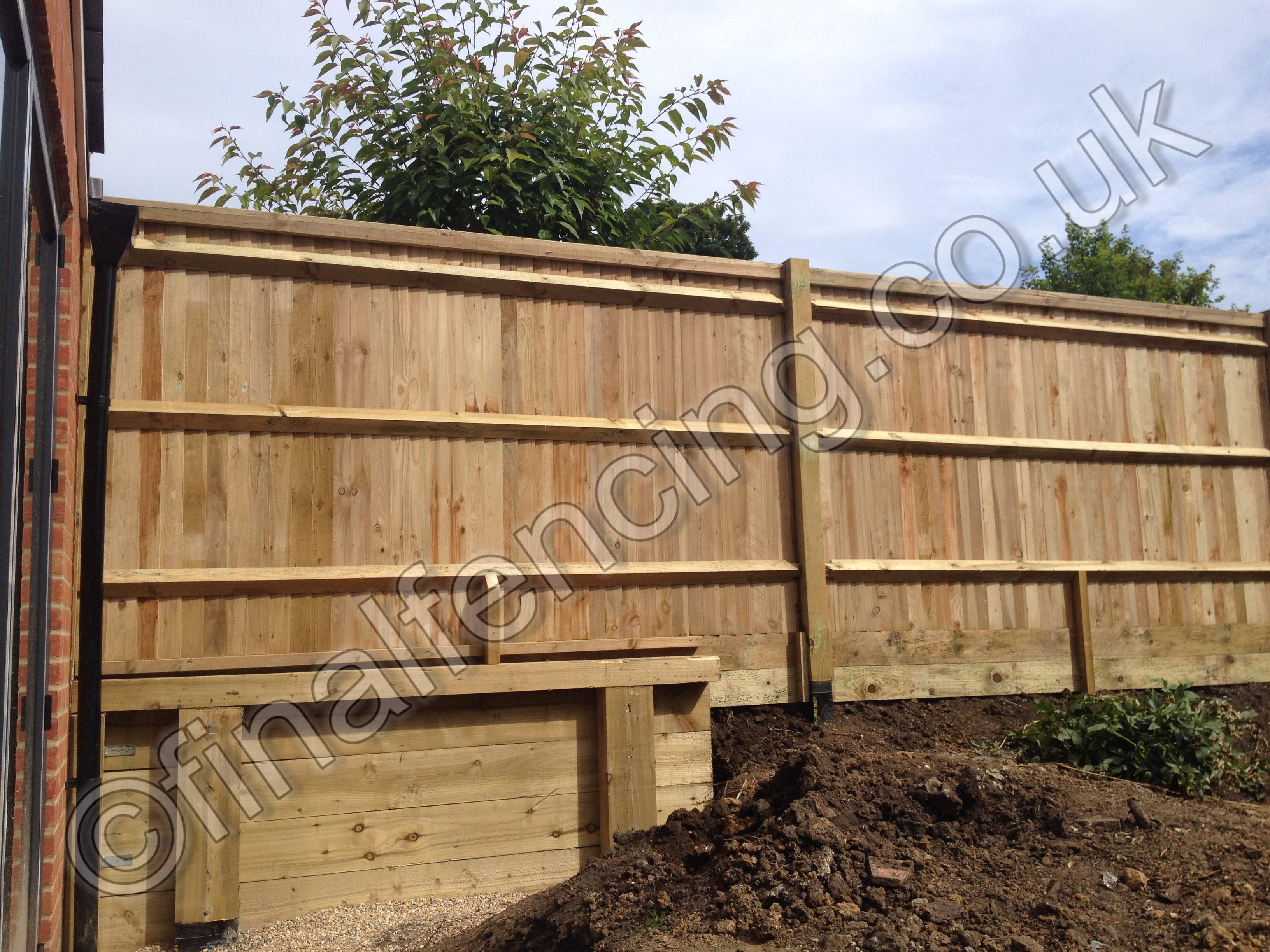 Green Closeboard with Softwood Retaining Wall