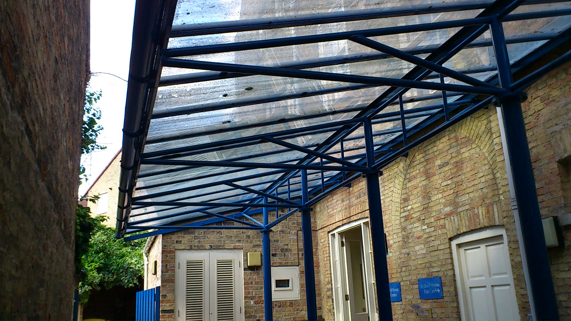 Glass entrance canopy cleaning - (Before).