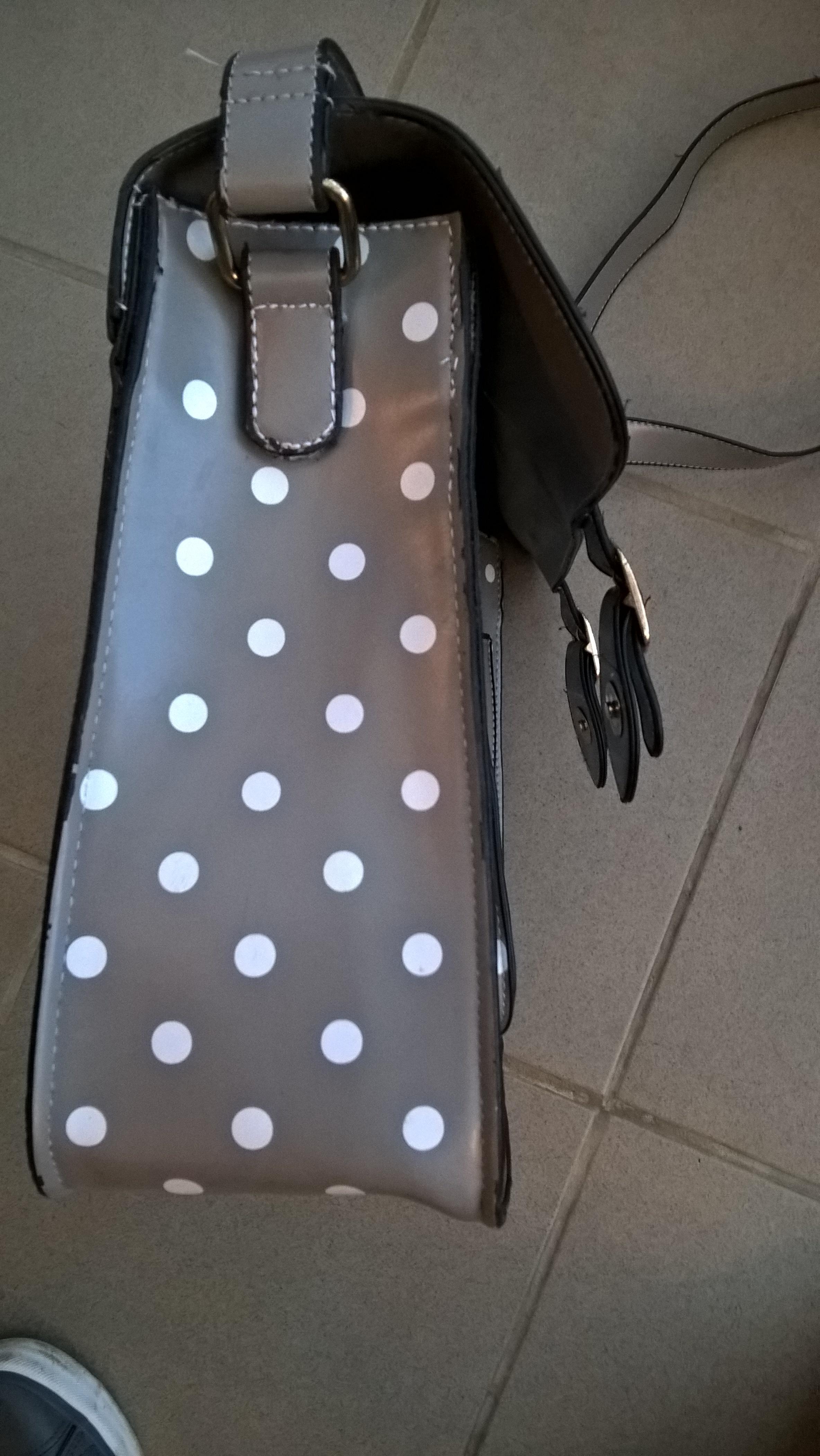 A re-sewn strap, a common repair for bags