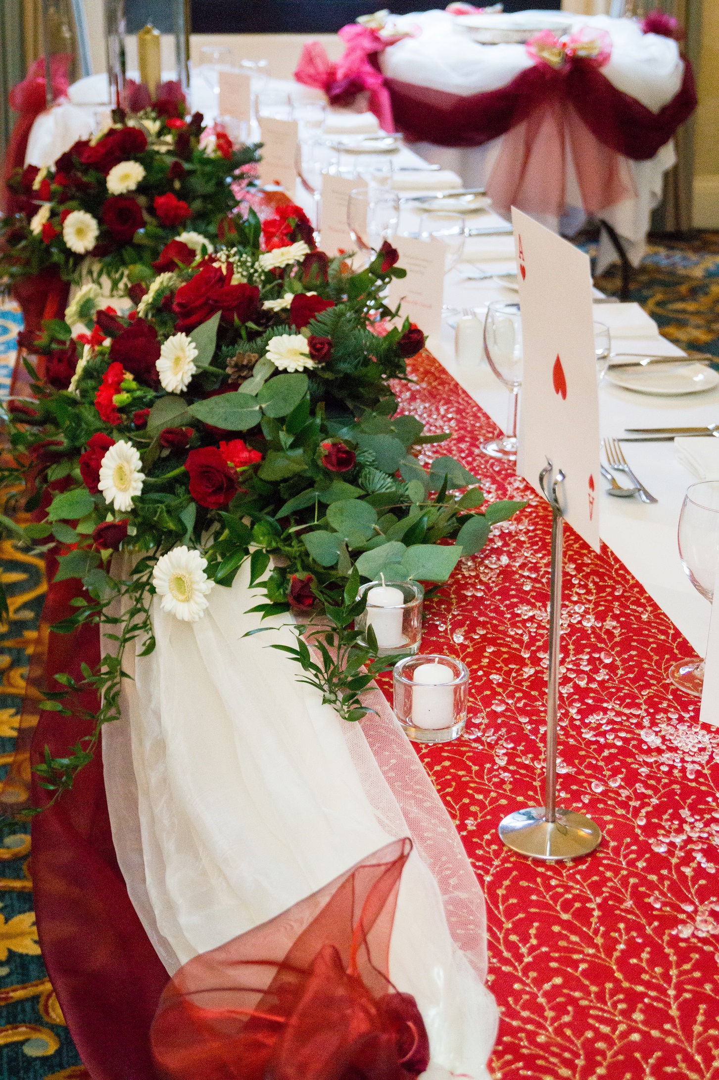 Hanbury Manor Wedding, Hertfordshire, wedding table decorations, red table flowers