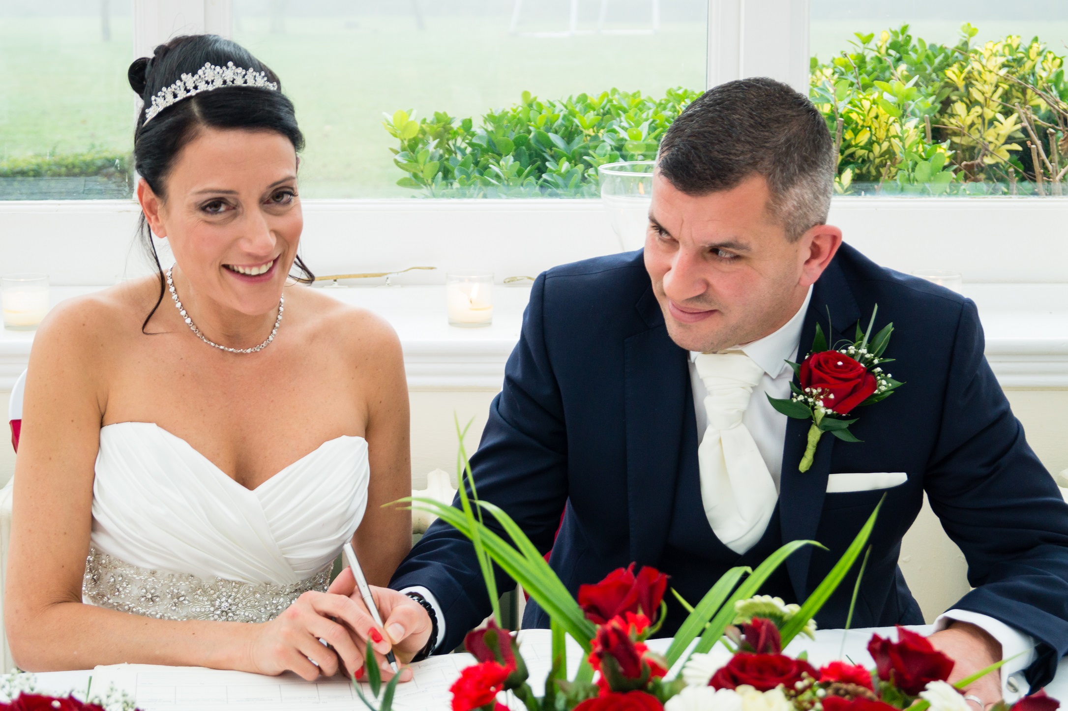 Hanbury Manor Wedding, Hertfordshire, bride and groom signing the registry