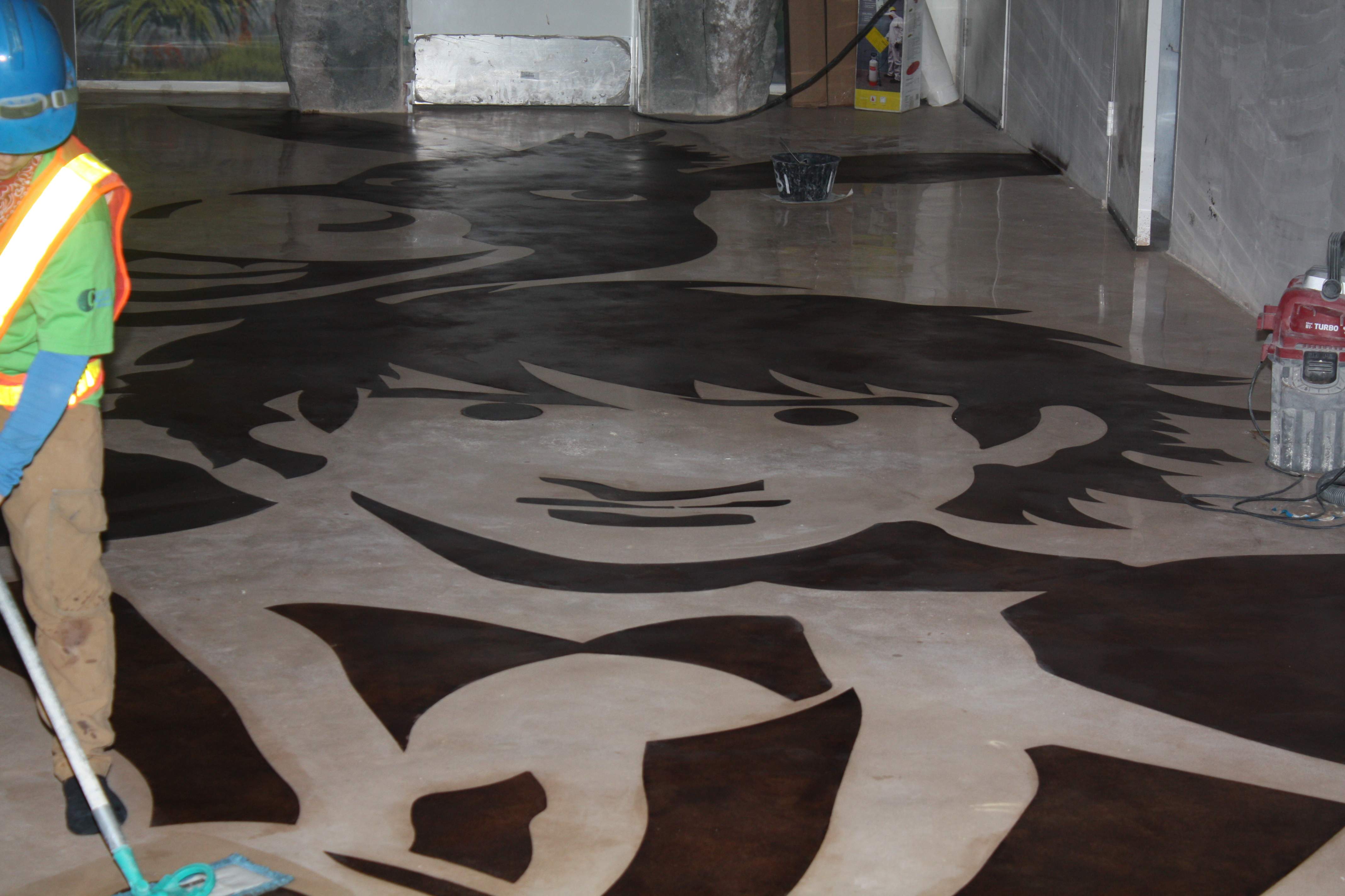 Installed decorative self -leveling material, installed stencil art work, polished.