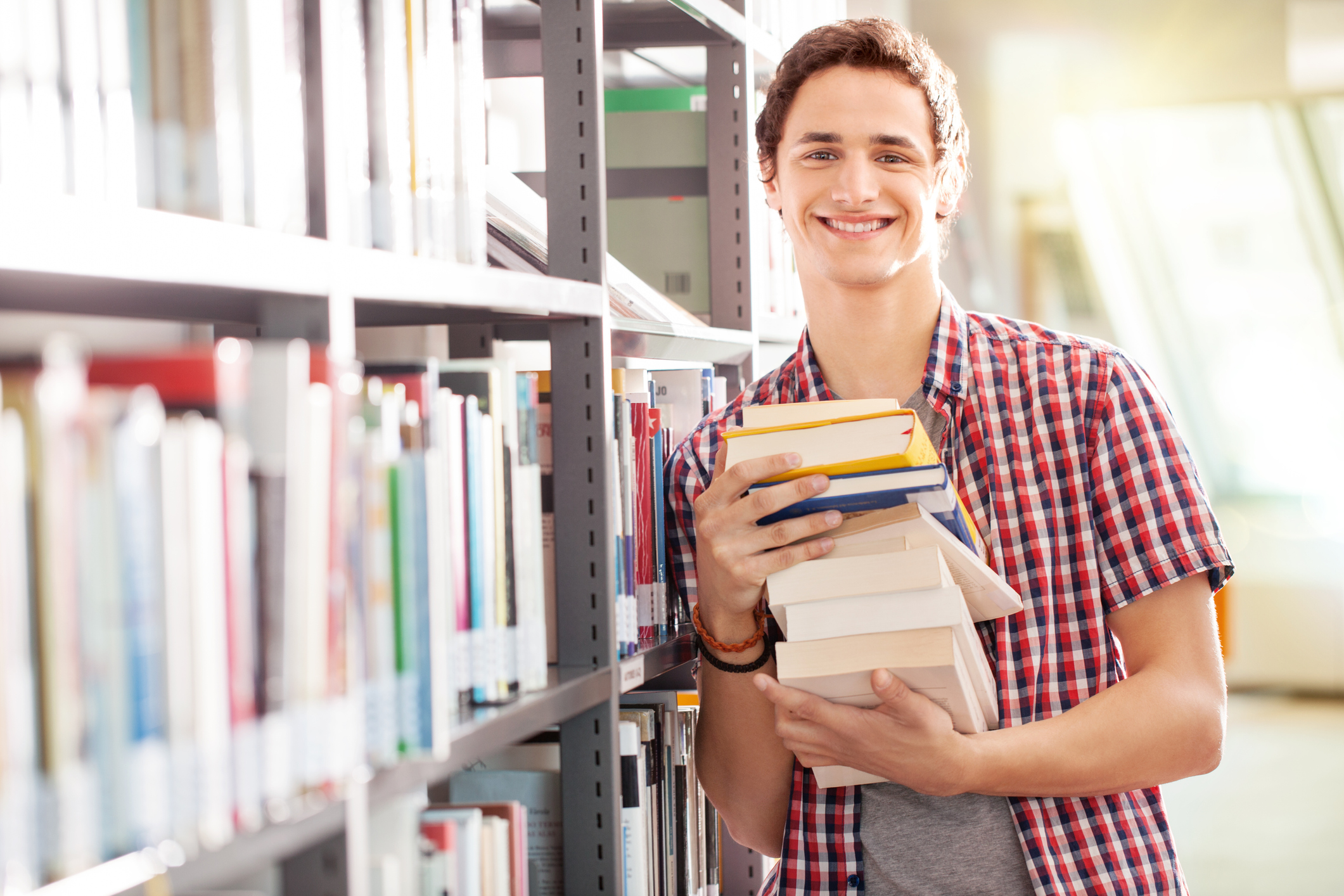young-student-with-books-in-libraryjpg