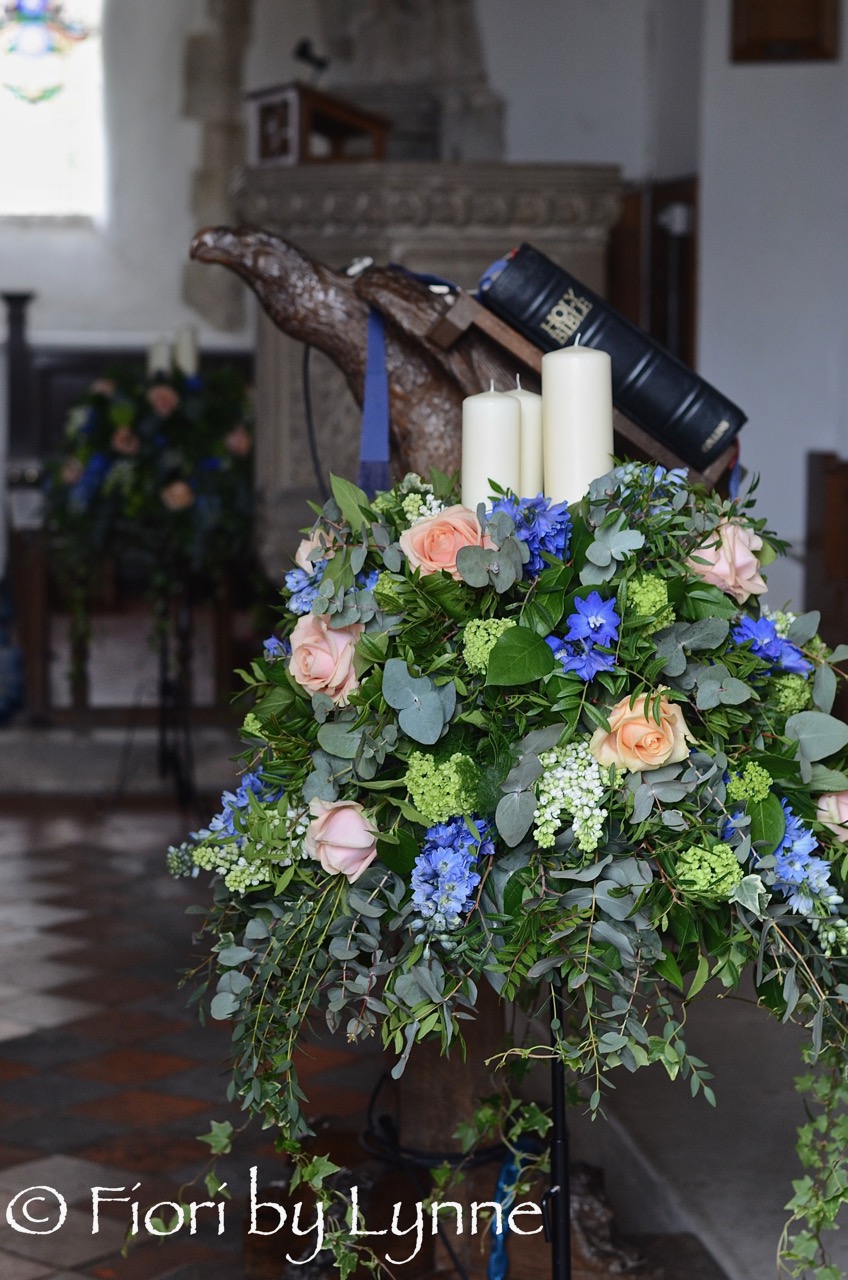 peach,blue,pedestal-flowers,candles,Spring-church-wedding.jpg