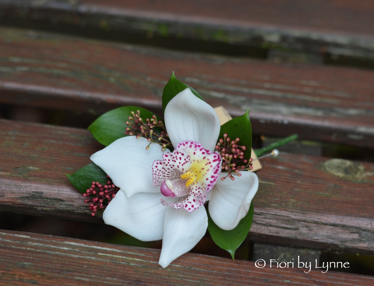 autumn-corsage-raspberry-white-orchid-skimmia.jpg