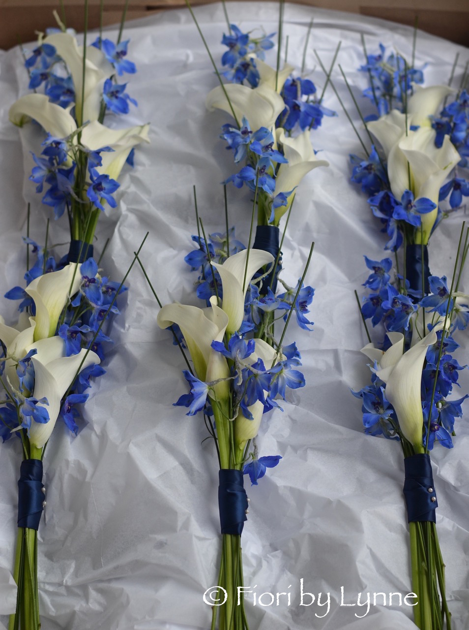 bridesmaidsposieswhitecallaliliesandbluedelphiniums-elegant.jpg