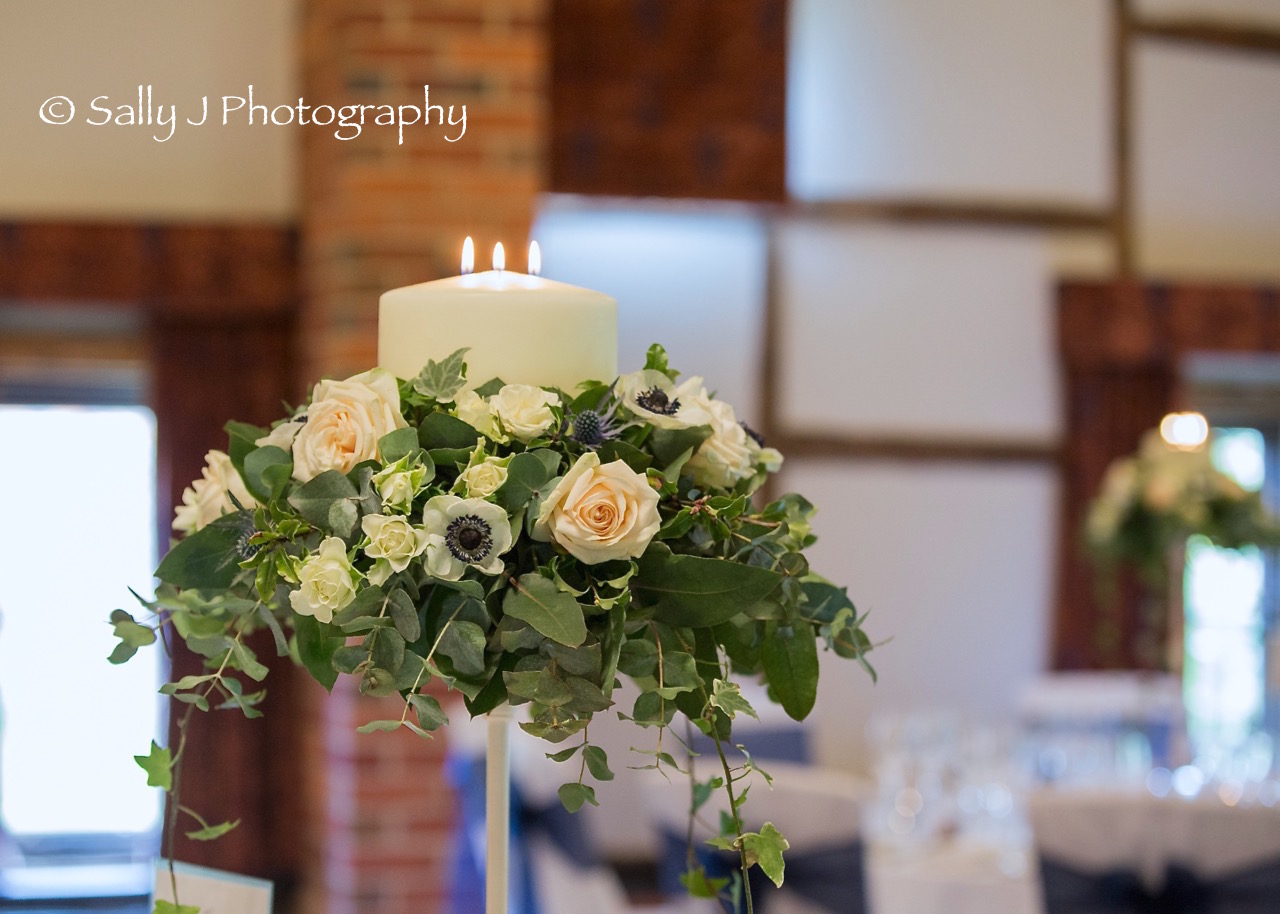 lainstonhouse-tall-tablecentre-with-candle-ivy-trails.jpg