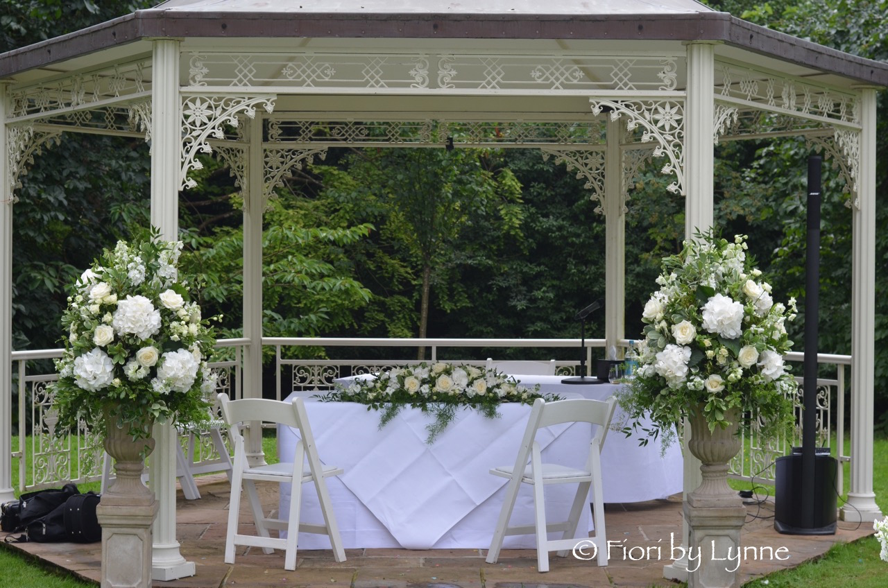 lainstonhouse-wedding-ceremony-flowers-outside-whites-greens.jpg