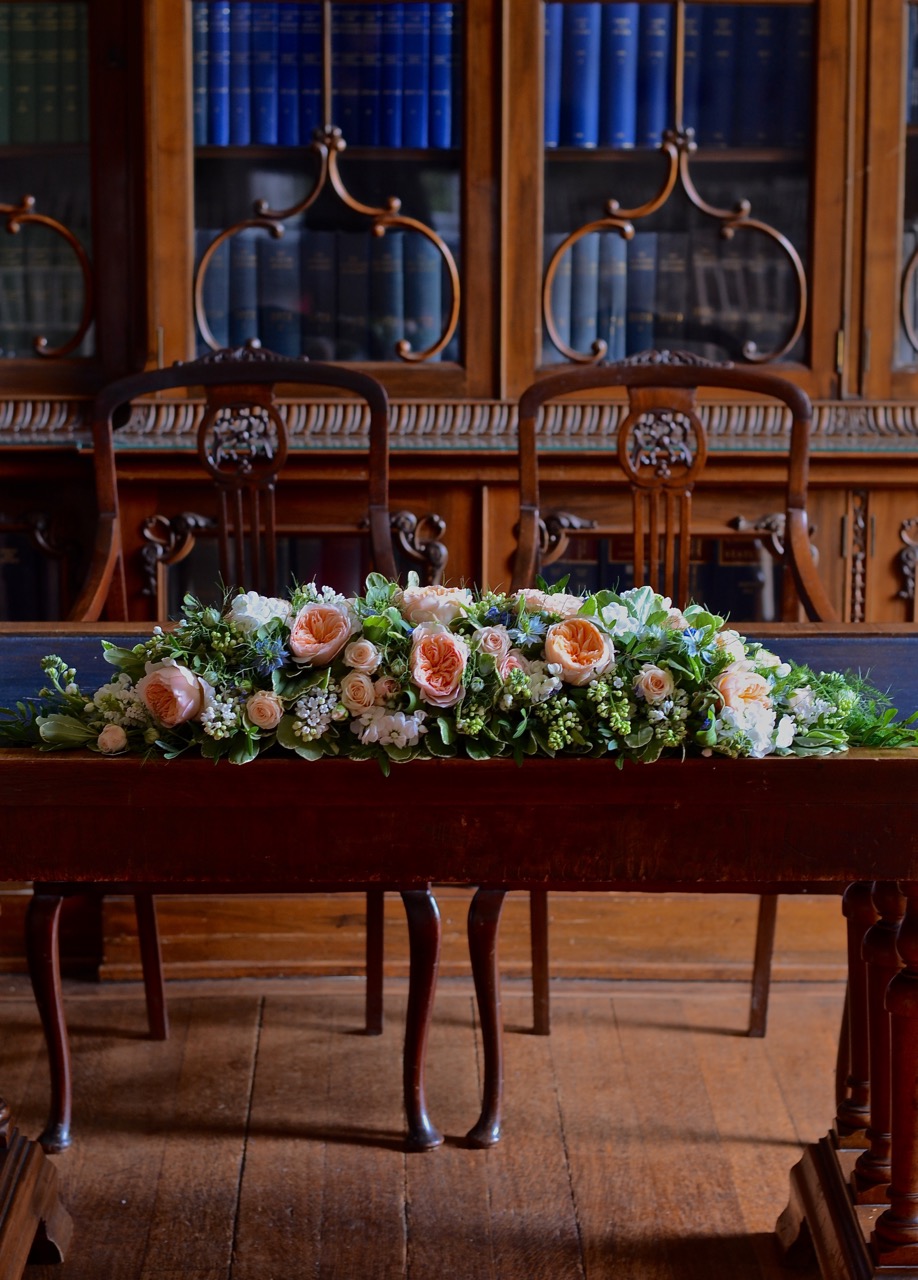 rownhamshouse-wedding-ceremony-tableflowers-peach-blue.jpg