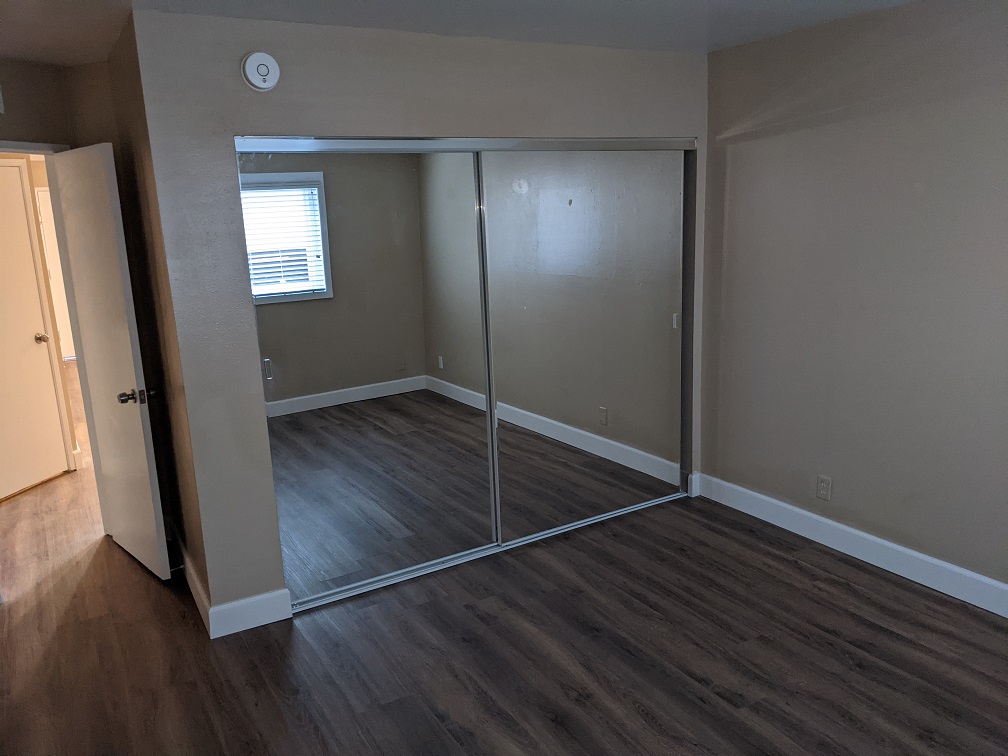 From inside, this is the closet with sliding mirror doors, with the entryway visible on the left