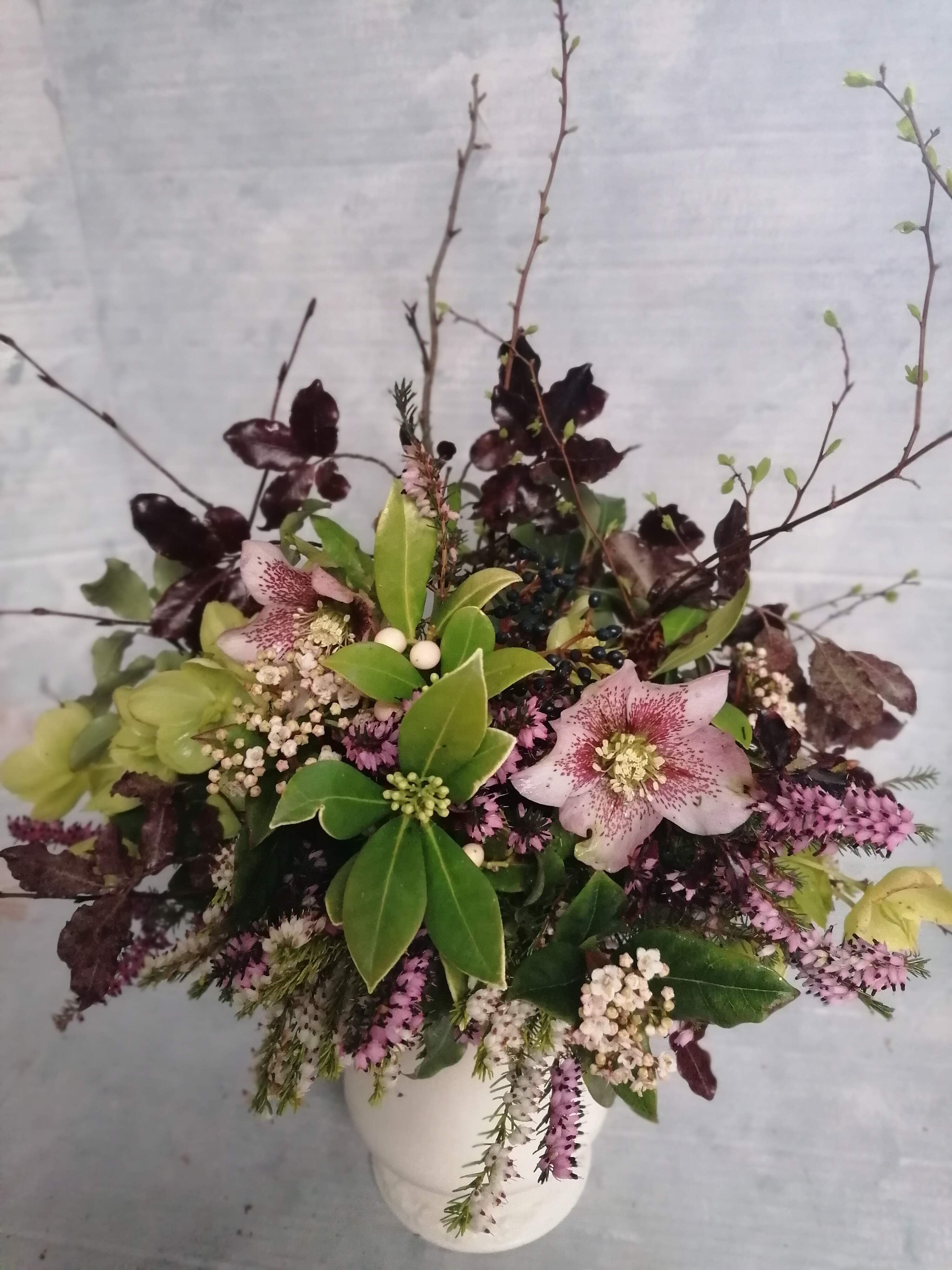 Hellebore , Pittosporoum and heather table arrangement. Locally grown seasonal flowers