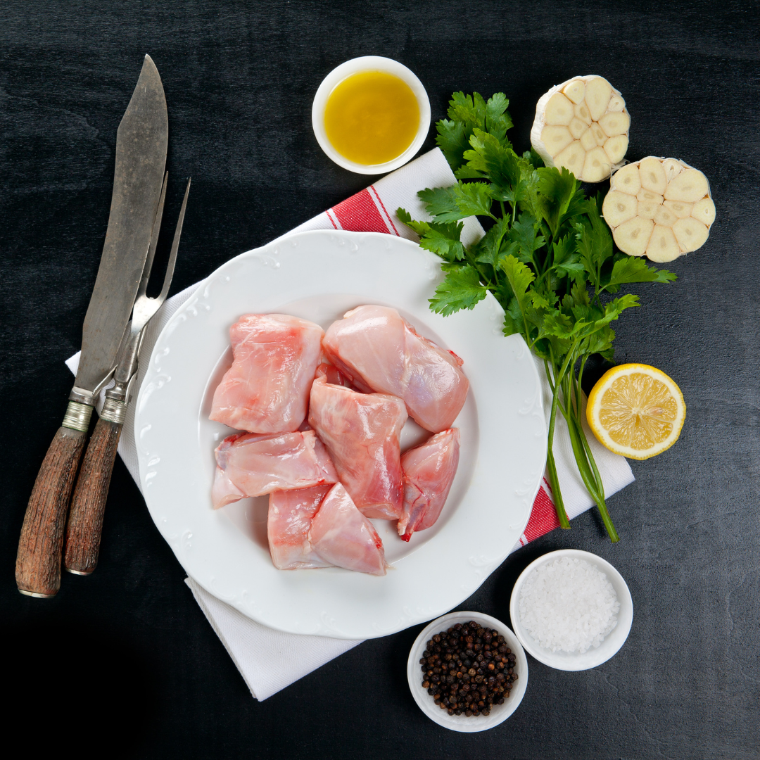 A plate of raw rabbit meat, ready to cook
