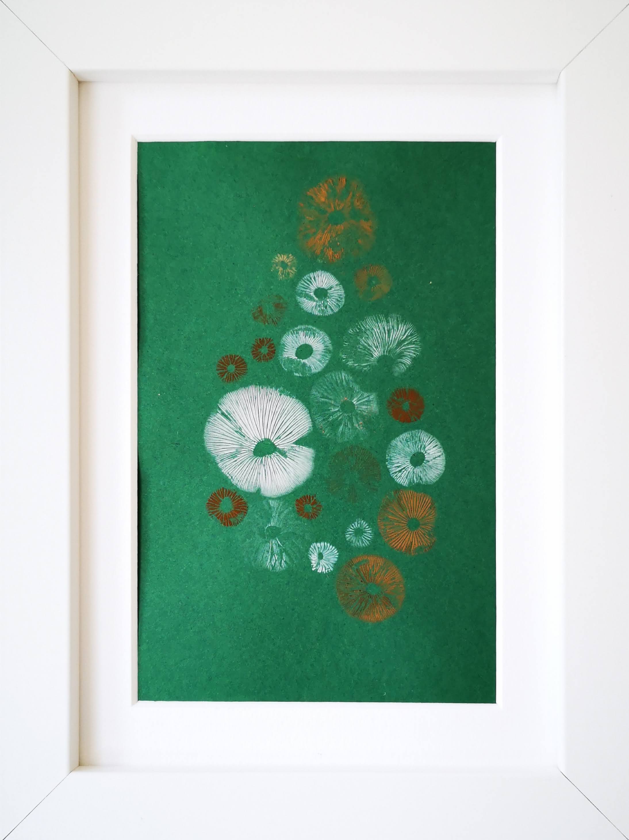Small multi coloured spores on green in white frame