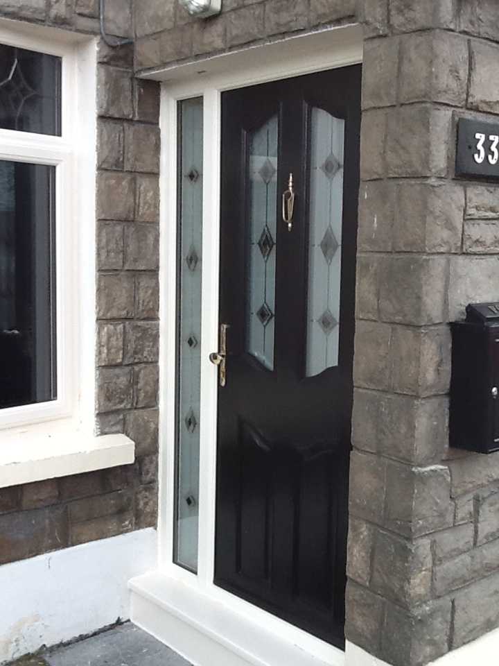 BLACK APEER COMPOSITE DOOR WITH CREAM FRAME FITTED IN DUBLIN 12.
