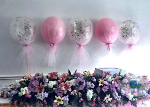 Tulle covered balloon centerpieces, confetti balloons on a stand