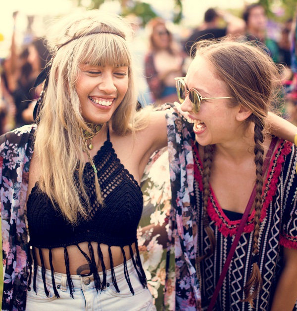 two happy women at a festival laughing, compact towels for festivals