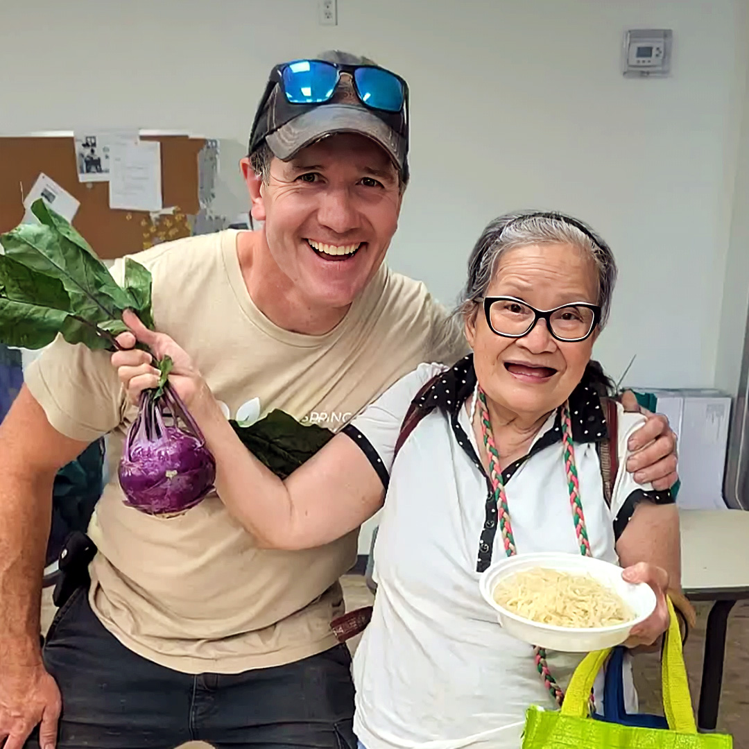 Farmer Glen Young and a happy recipient of donated food to the UHN Social Medicine Supportive Housing Project