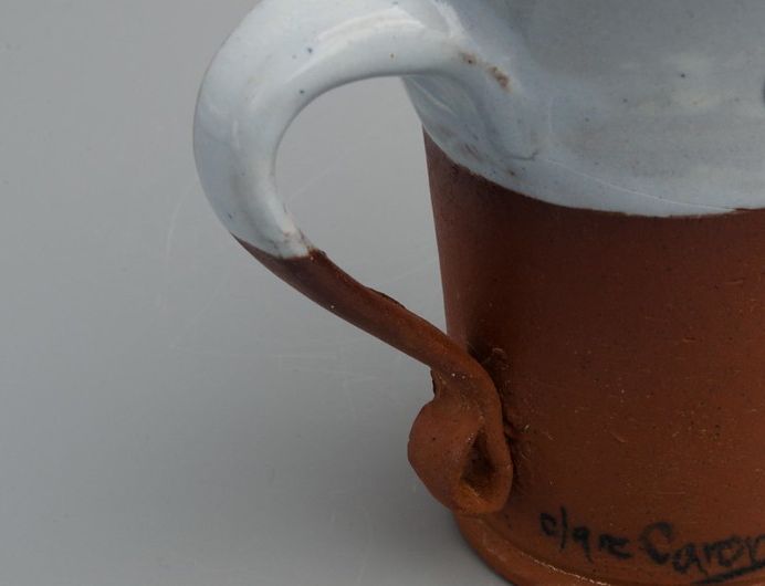 Earthenware cup with majolica glaze