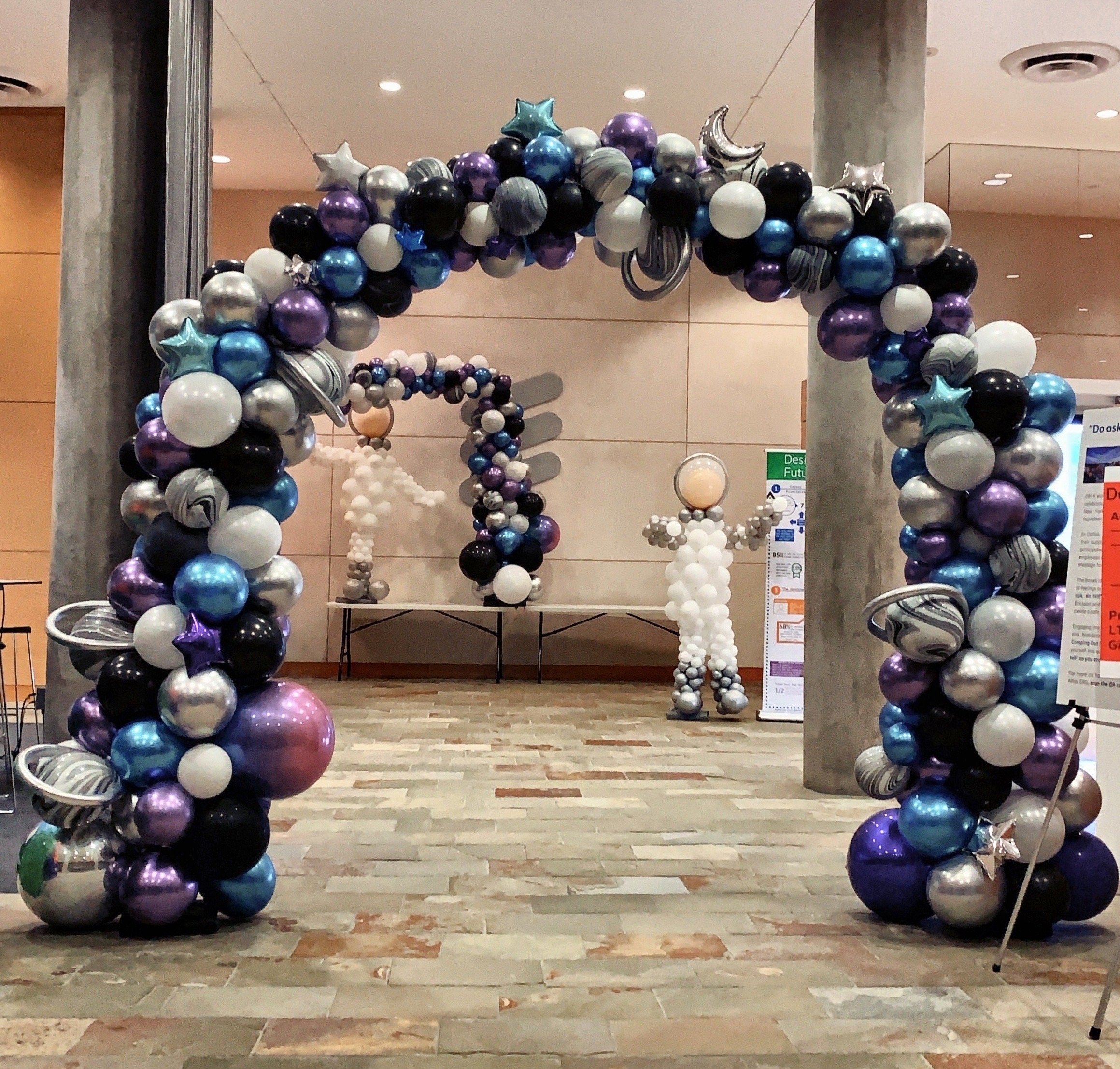 Space themed organic balloon arch