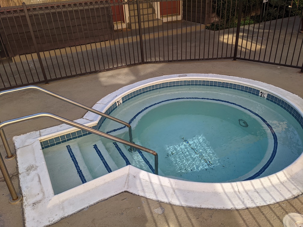 Adjacent to the pool, also known as a "jacuzzi"
