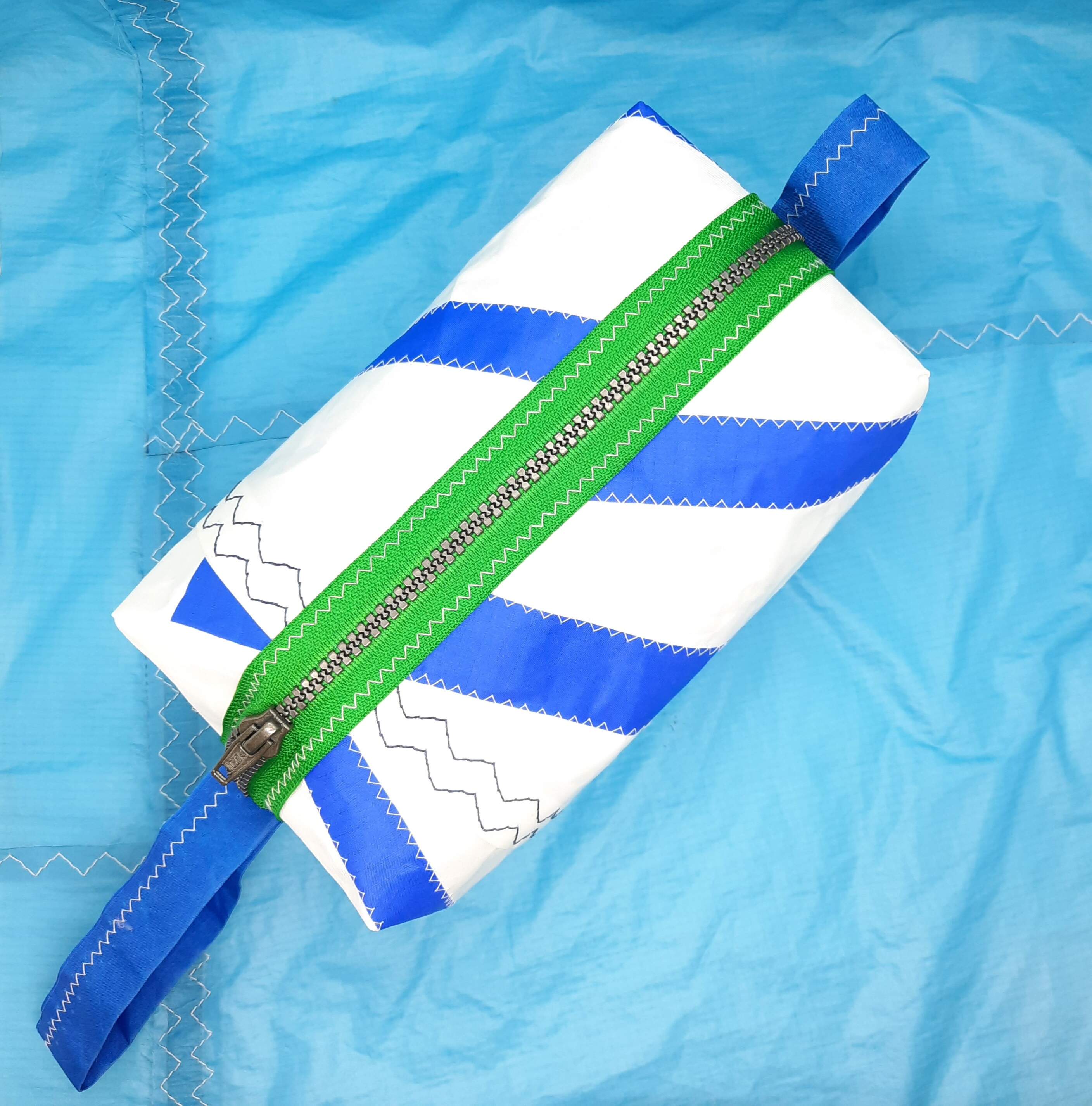 Wash Bag with blue stripes and a green zip