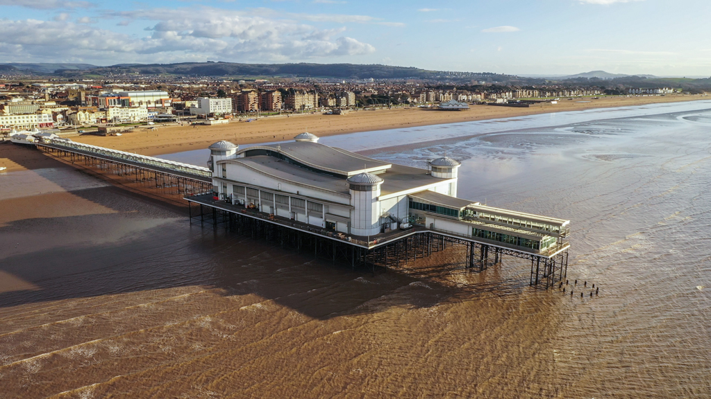 Aerial sequence depicting the Grand Pier at Weston-super-Mare, a popular tourist destination.