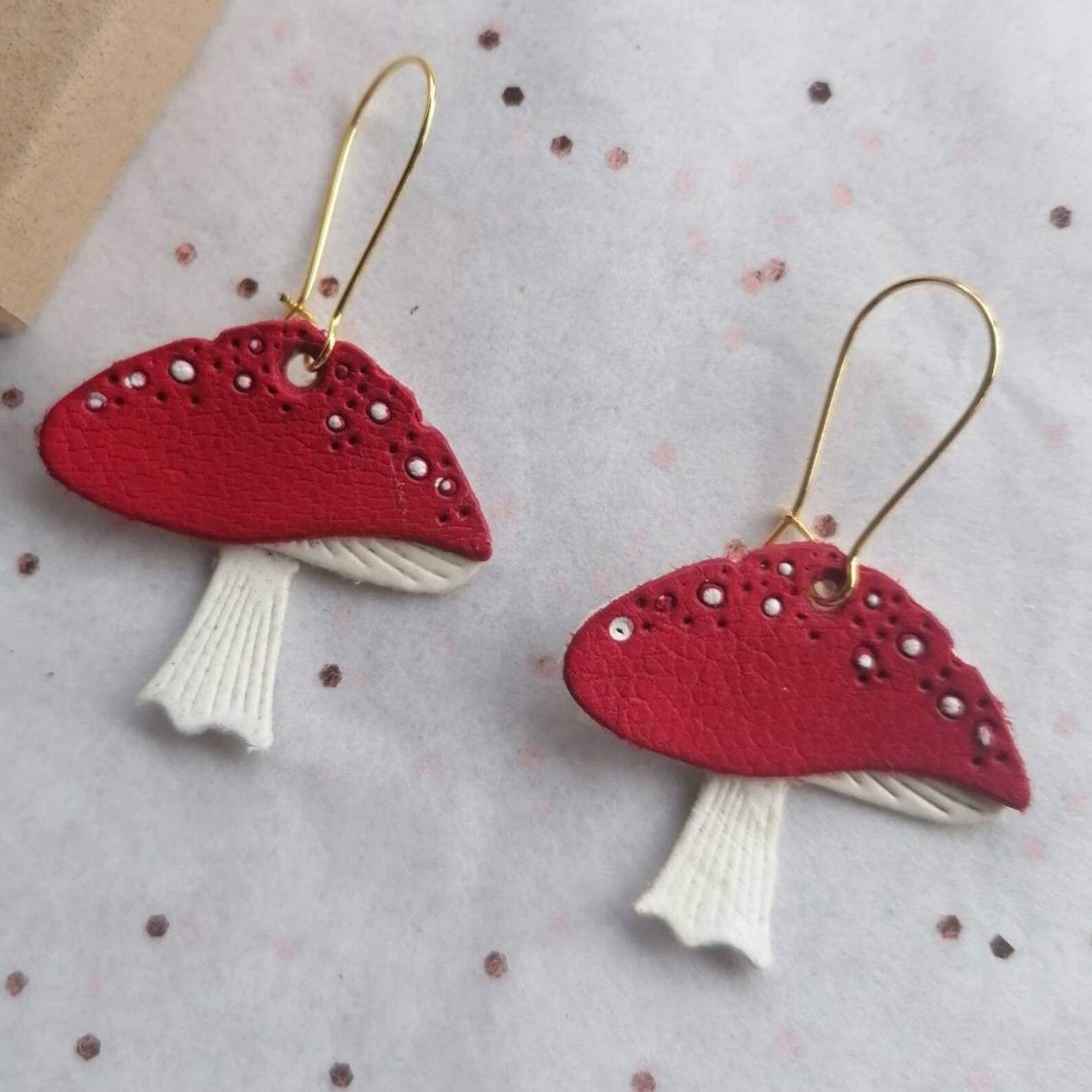 Red and white leather mushrooms on gold coloured closed ear wires