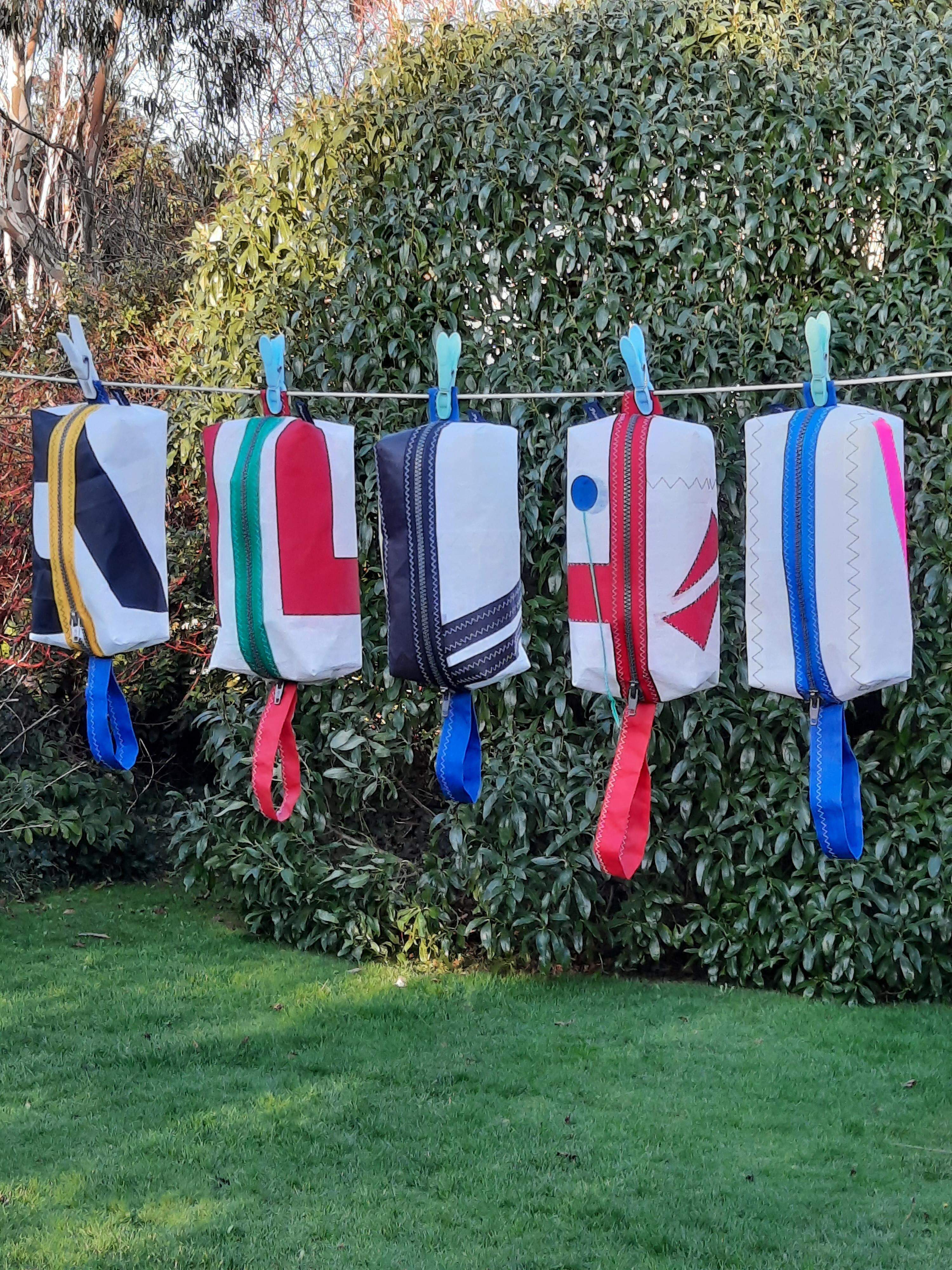 5 colourful wash bags hanging on the line