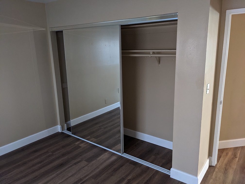 Here is the closet in the side bedroom, with the entry door on the right