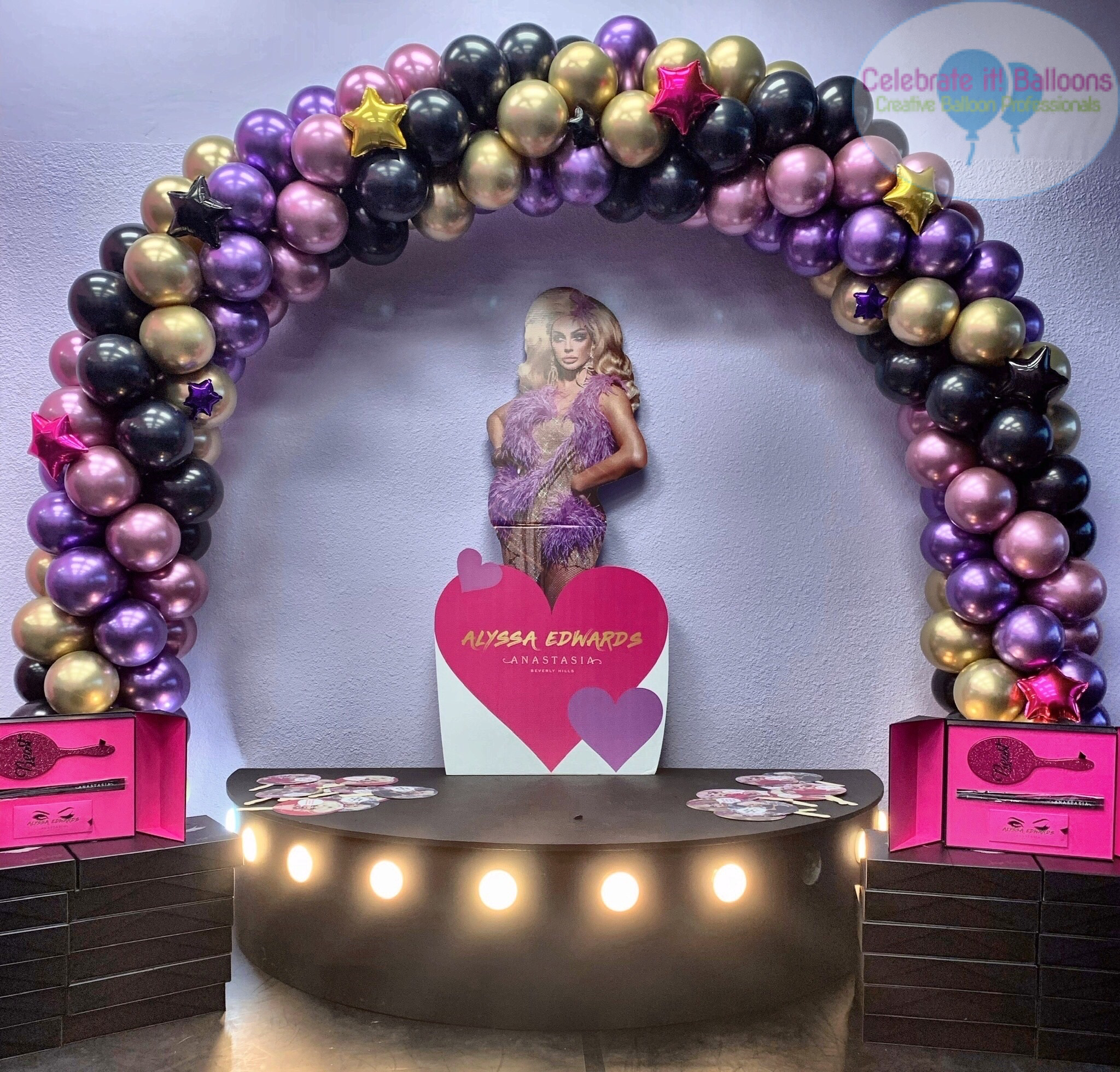 Classic swirl balloon arch with chrome gold, chrome mauve, chrome purple and pearl black balloons