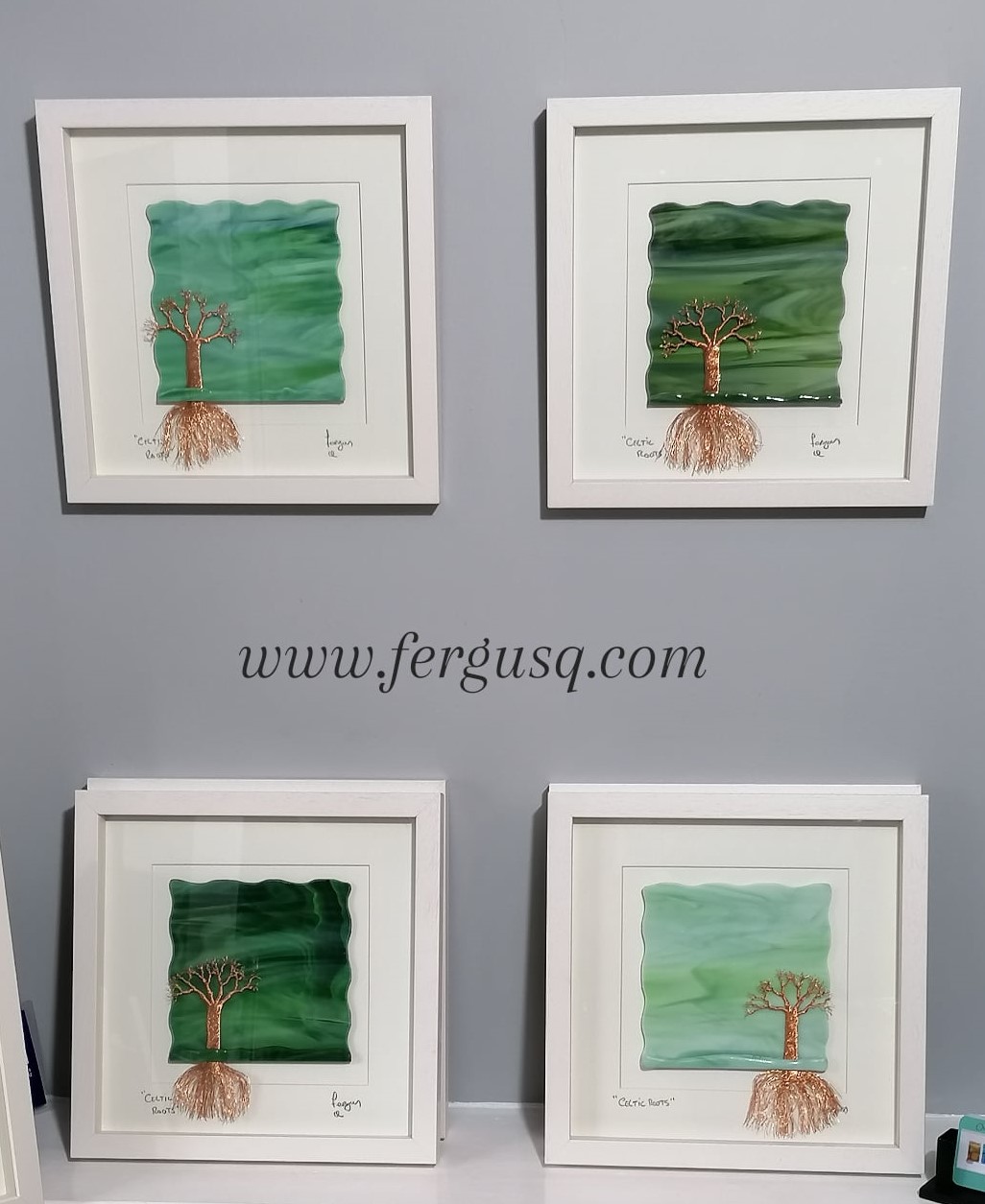 A Group of  "Celtic Roots" Glass Art pictures Different shades of Green with a handmade Copper wire tree with roots.