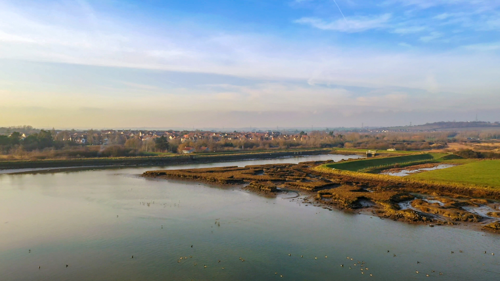 Aerial sequence depicting the wetlands at Hawbush Creek on the outskirts of an Essex town.