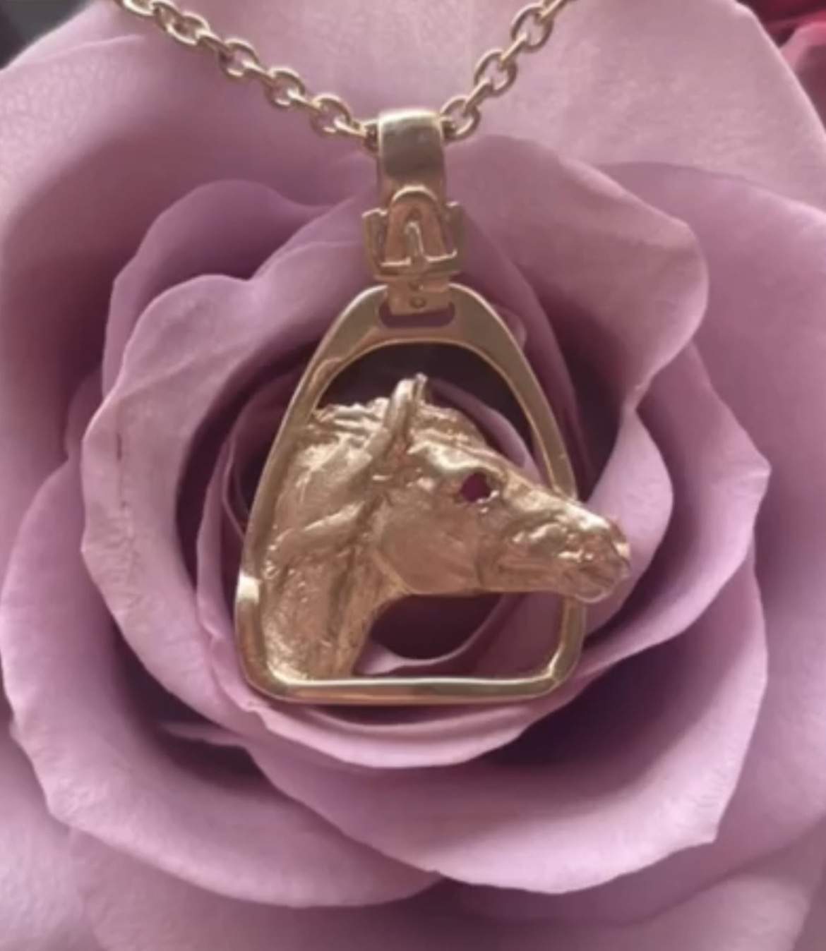 Horse’s head in stirrup pendant on chain