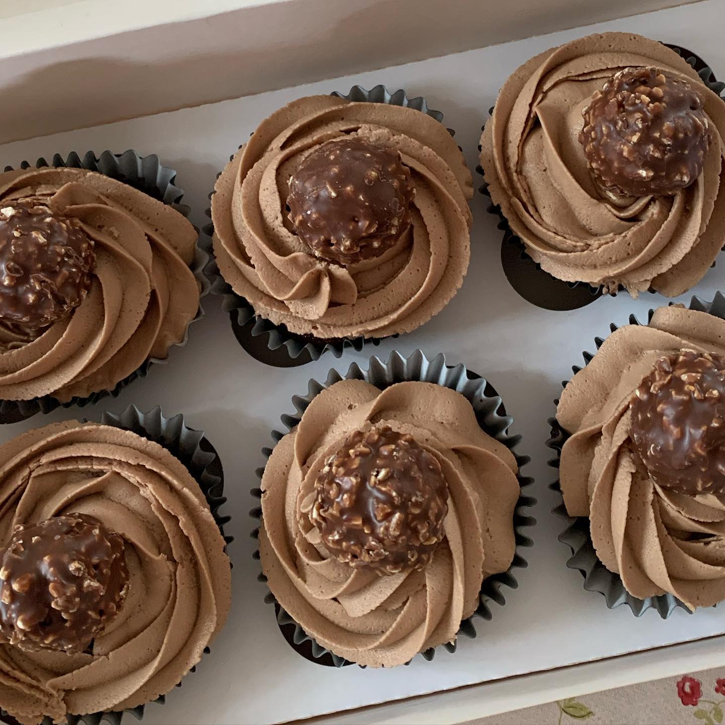 Cupcakes with chocolate frosting and ferrero rocher on top