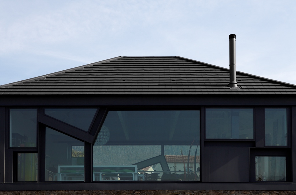 CS Plasma clay tile, Anthracite slate colour on 12.5 degree roof of architects home, CS Plasma ridge