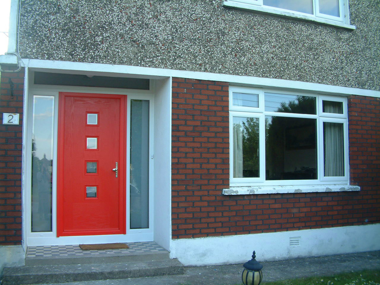 TRAFFIC RED APEER COMPOSITE FRONT DOOR WITH WHITE FRAME FITTED BY ASGARD WINDOWS IN DUBLIN 14.