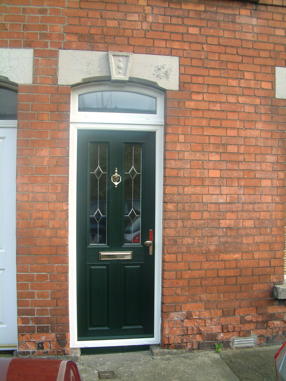 DARK GREEN APEER COMPOSITE DOOR WITH WHITE FRAME FITTED BY ASGARD WINDOWS IN DUBLIN 6.