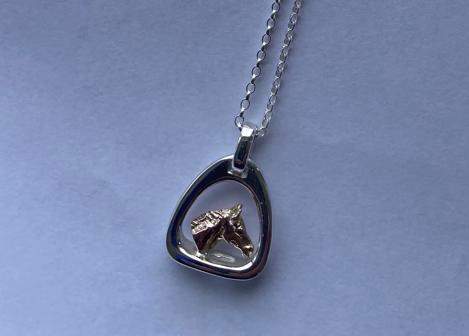 Small horse’s head in stirrup pendant on chain