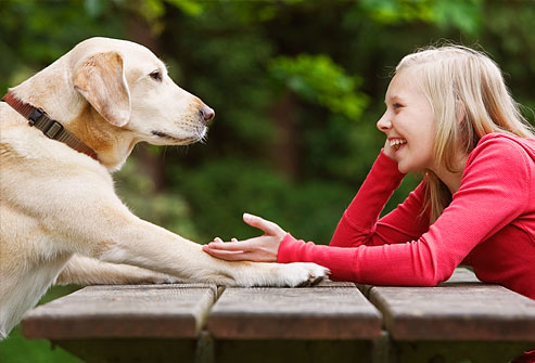 getty_rf_photo_of_girl_relaxing_while_talking_to_dog.jpg
