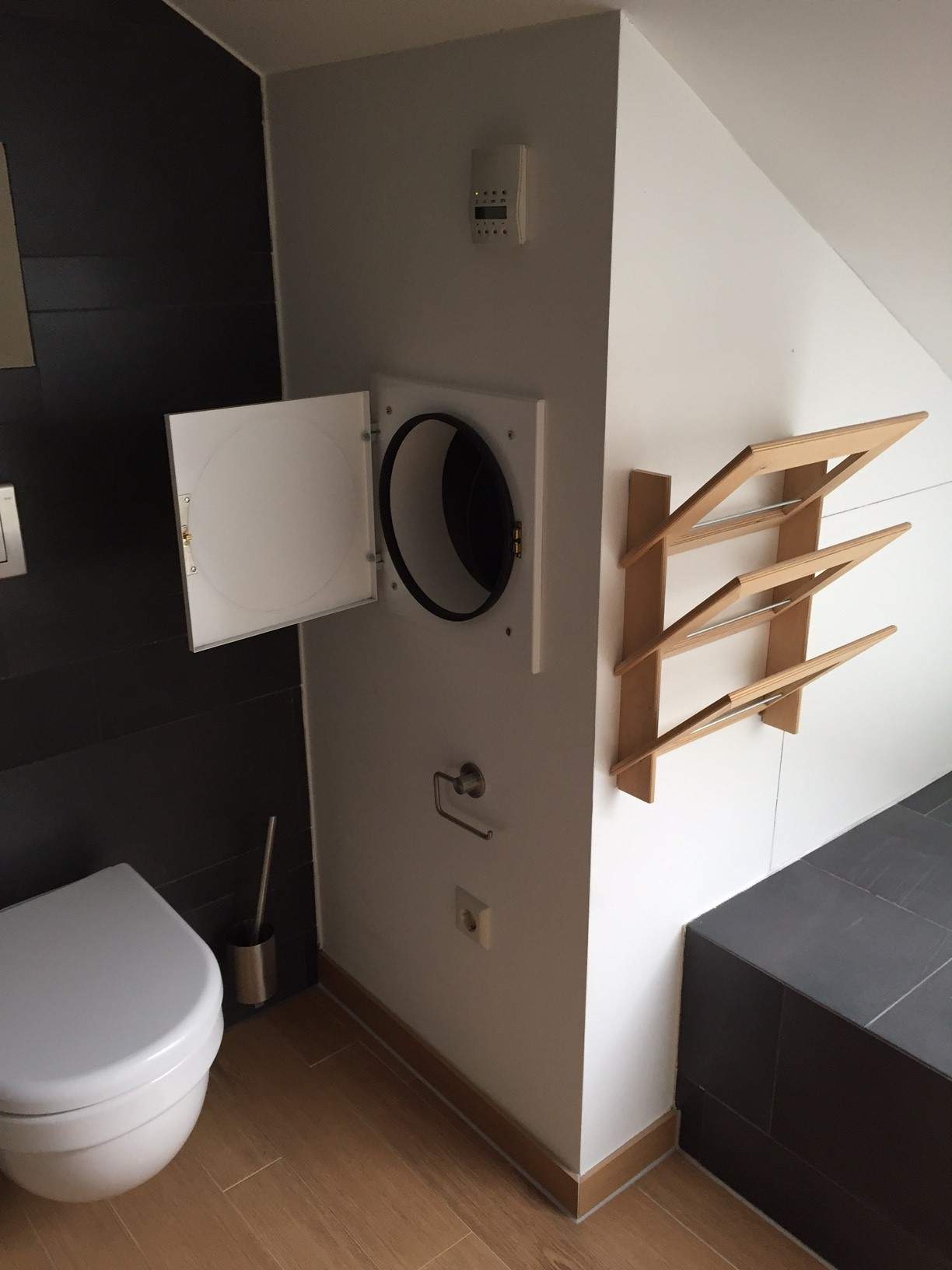 A completed laundry chute inside a bathroom