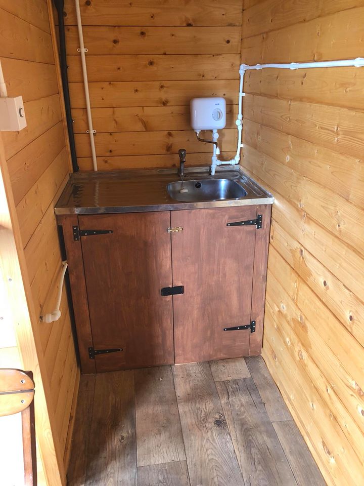 The sink and water heater in the Glenquicken glamping sheds