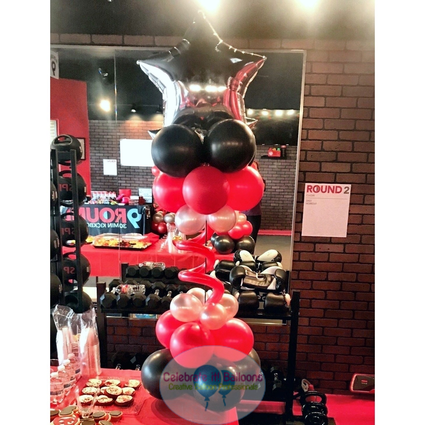 Red, black and silver balloon centerpiece on a stand