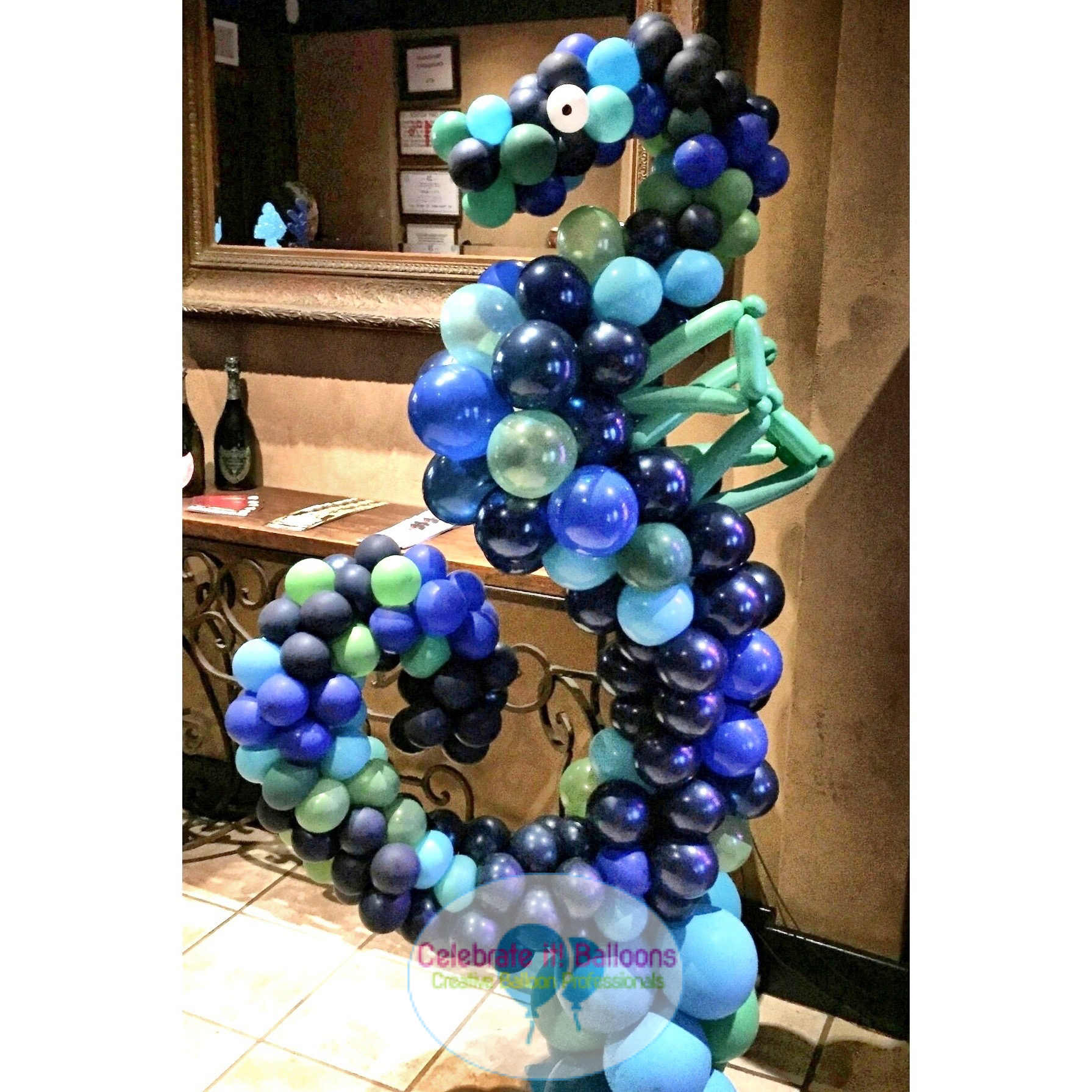 Seahorse built with balloons in shades of blue and green